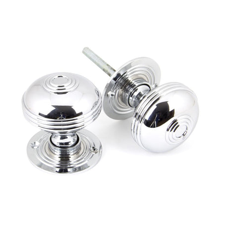 This is an image showing From The Anvil - Polished Chrome 63mm Prestbury Mortice/Rim Knob Set available from trade door handles, quick delivery and discounted prices