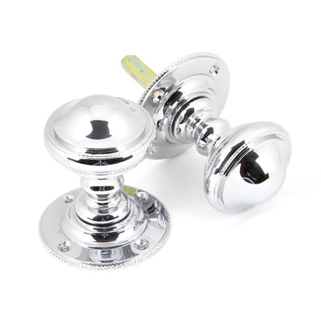 This is an image showing From The Anvil - Polished Chrome Brockworth Mortice Knob Set available from trade door handles, quick delivery and discounted prices