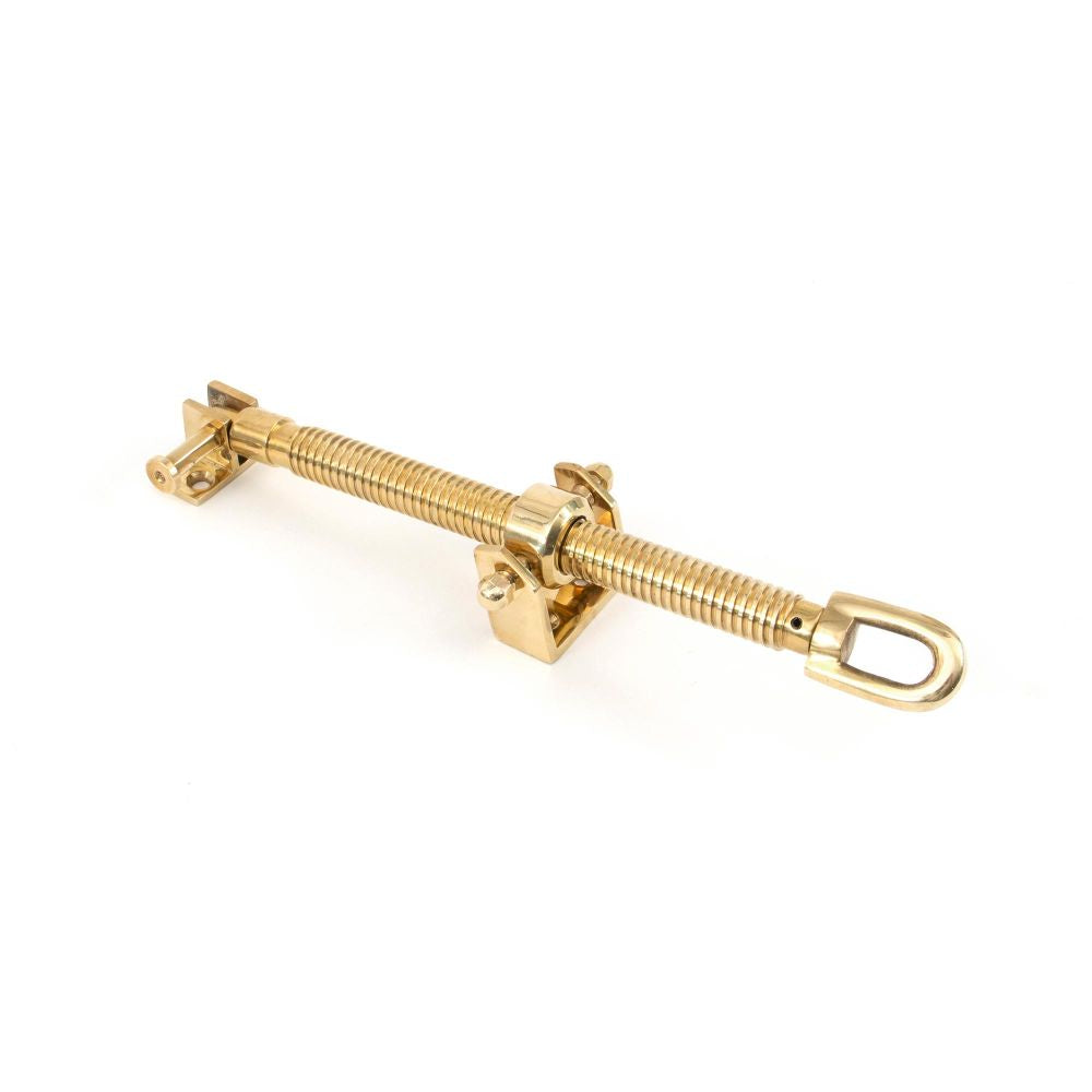 This is an image showing From The Anvil - Polished Brass 12" Fanlight Screw Opener available from trade door handles, quick delivery and discounted prices