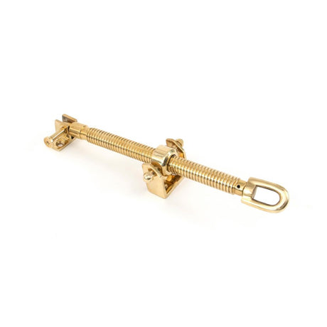 This is an image showing From The Anvil - Polished Brass 12" Fanlight Screw Opener available from trade door handles, quick delivery and discounted prices