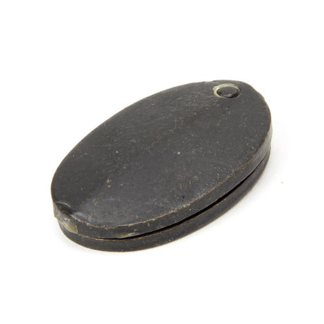 This is an image showing From The Anvil - External Beeswax Oval Escutcheon & Cover available from trade door handles, quick delivery and discounted prices