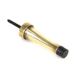 This is an image showing From The Anvil - Aged Brass Projection Door Stop available from trade door handles, quick delivery and discounted prices