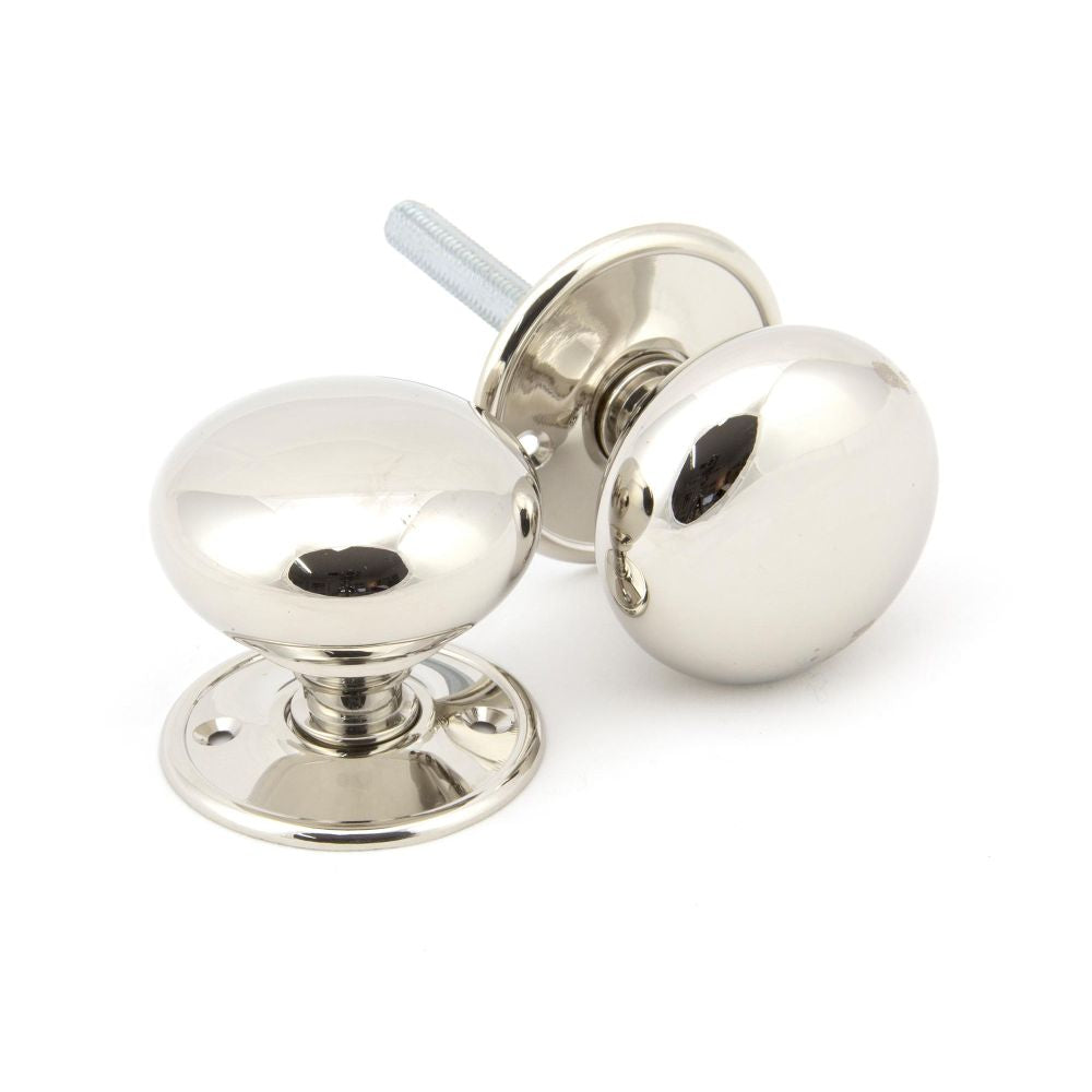 This is an image showing From The Anvil - Polished Nickel 57mm Mushroom Mortice/Rim Knob Set available from trade door handles, quick delivery and discounted prices