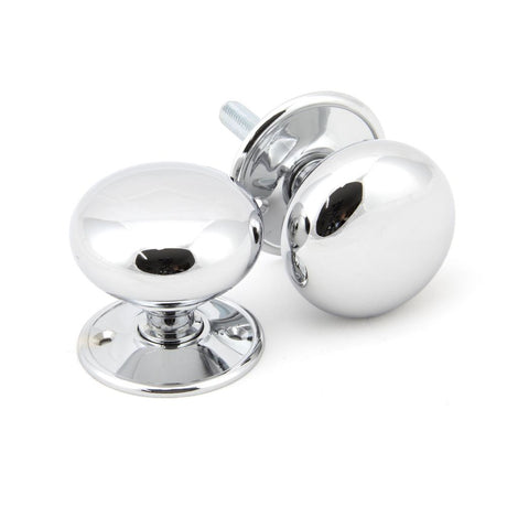 This is an image showing From The Anvil - Polished Chrome 57mm Mushroom Mortice/Rim Knob Set available from trade door handles, quick delivery and discounted prices