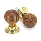 This is an image showing From The Anvil - Rosewood & Polished Brass Beehive Mortice/Rim Knob Set available from trade door handles, quick delivery and discounted prices