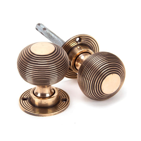 This is an image showing From The Anvil - Polished Bronze Heavy Beehive Mortice/Rim Knob Set available from trade door handles, quick delivery and discounted prices