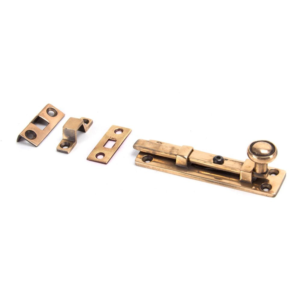 This is an image showing From The Anvil - Polished Bronze 4" Universal Bolt available from trade door handles, quick delivery and discounted prices