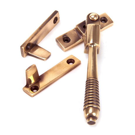 This is an image showing From The Anvil - Polished Bronze Night-Vent Locking Reeded Fastener available from trade door handles, quick delivery and discounted prices