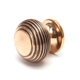 This is an image showing From The Anvil - Polished Bronze Beehive Cabinet Knob 30mm available from trade door handles, quick delivery and discounted prices