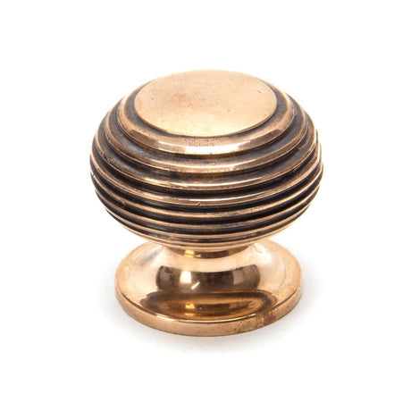 This is an image showing From The Anvil - Polished Bronze Beehive Cabinet Knob 30mm available from trade door handles, quick delivery and discounted prices