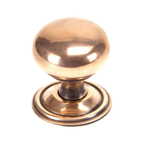 This is an image showing From The Anvil - Polished Bronze Mushroom Cabinet Knob 38mm available from trade door handles, quick delivery and discounted prices