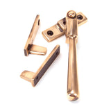 This is an image showing From The Anvil - Polished Bronze Night-Vent Locking Newbury Fastener available from trade door handles, quick delivery and discounted prices