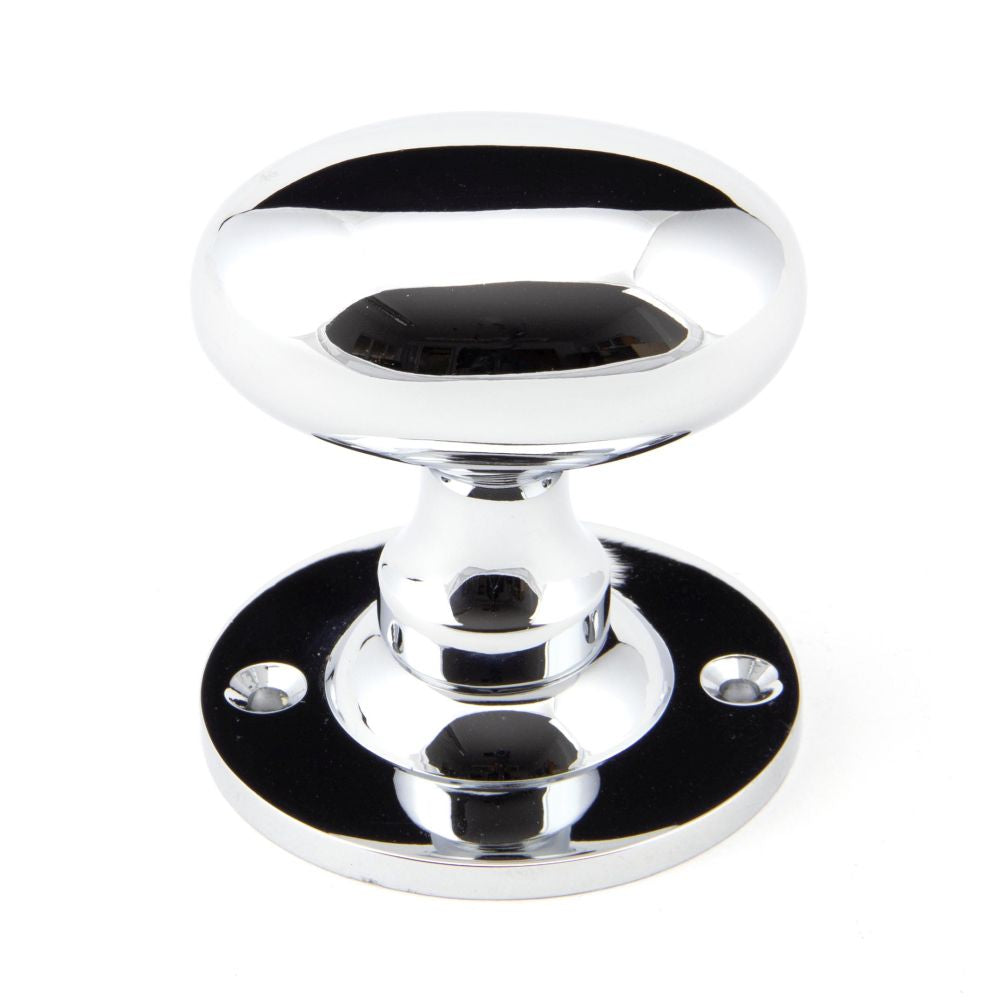 This is an image showing From The Anvil - Polished Chrome Oval Mortice/Rim Knob Set available from trade door handles, quick delivery and discounted prices