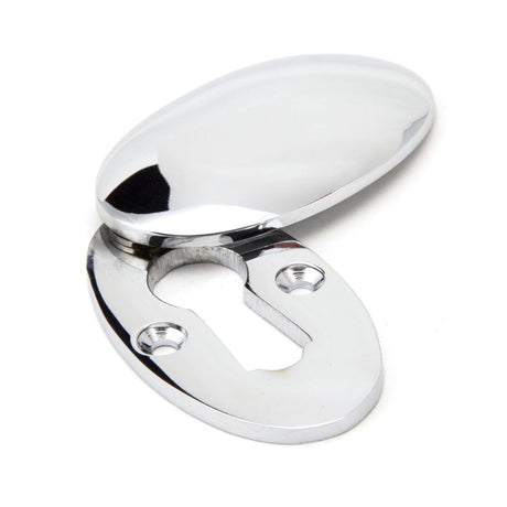 This is an image showing From The Anvil - Polished Chrome Oval Escutcheon & Cover available from trade door handles, quick delivery and discounted prices