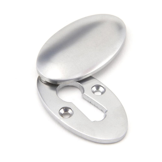 This is an image showing From The Anvil - Satin Chrome Oval Escutcheon & Cover available from trade door handles, quick delivery and discounted prices