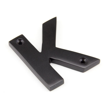 This is an image showing From The Anvil - Aged Bronze Letter K available from trade door handles, quick delivery and discounted prices