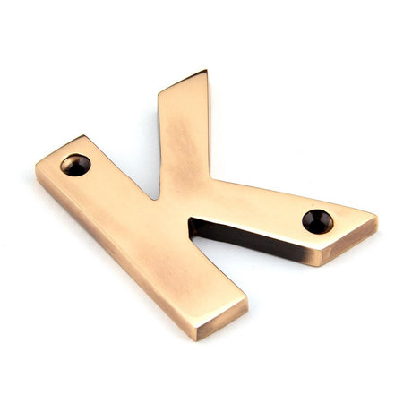 This is an image showing From The Anvil - Polished Bronze Letter K available from trade door handles, quick delivery and discounted prices