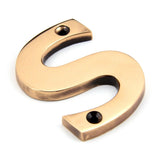 This is an image showing From The Anvil - Polished Bronze Letter S available from trade door handles, quick delivery and discounted prices