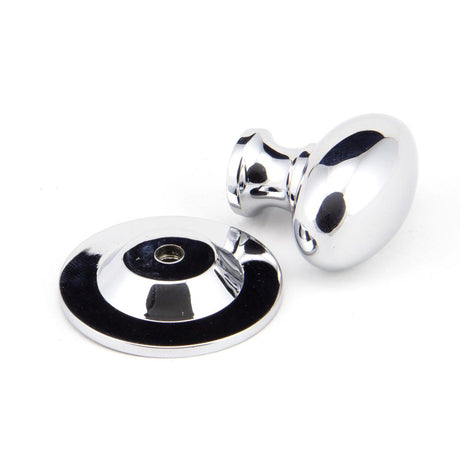 This is an image showing From The Anvil - Polished Chrome Oval Cabinet Knob 33mm available from trade door handles, quick delivery and discounted prices