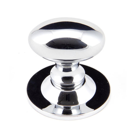 This is an image showing From The Anvil - Polished Chrome Oval Cabinet Knob 33mm available from trade door handles, quick delivery and discounted prices