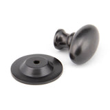 This is an image showing From The Anvil - Aged Bronze Oval Cabinet Knob 33mm available from trade door handles, quick delivery and discounted prices