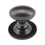 This is an image showing From The Anvil - Aged Bronze Oval Cabinet Knob 33mm available from trade door handles, quick delivery and discounted prices