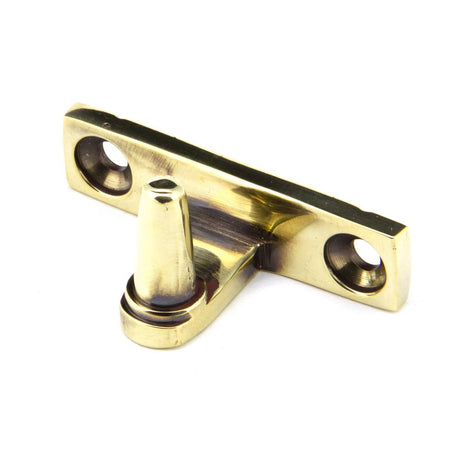 This is an image showing From The Anvil - Aged Brass Cranked Stay Pin available from trade door handles, quick delivery and discounted prices