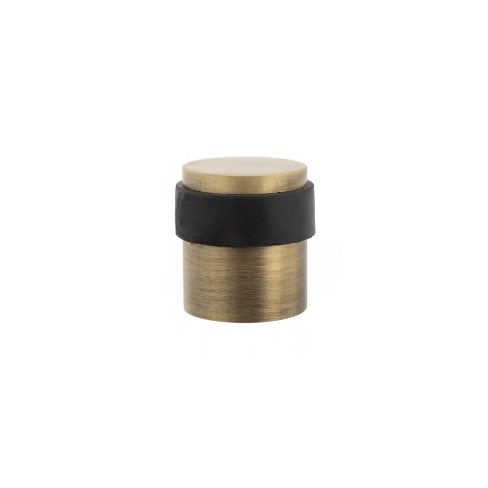 This is an image of Atlantic Cylinder Premium Floor Mounted Door Stop - Matt Antique Brass available to order from Trade Door Handles.