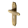 This is an image of a Heritage Brass - Door Handle Lever Lock Astoria Design Antique Brass Finish, ast5900-at that is available to order from Trade Door Handles in Kendal.