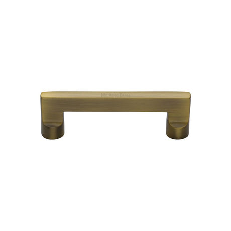 This is an image of a Heritage Brass - Cabinet Pull Apollo Design 96mm CTC Antique Brass Finish, c0345-96-at that is available to order from Trade Door Handles in Kendal.