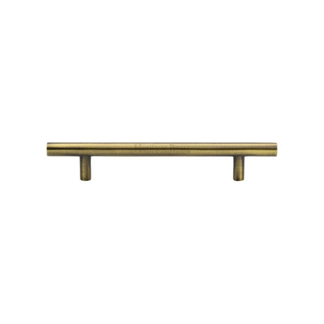 This is an image of a Heritage Brass - Cabinet Pull T-Bar Design 128mm CTC Antique Brass Finish, c0361-128-at that is available to order from Trade Door Handles in Kendal.