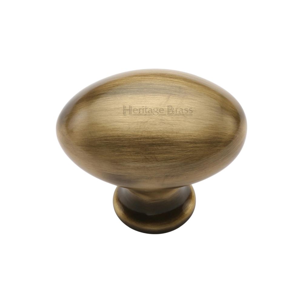 This is an image of a Heritage Brass - Cabinet Knob Victorian Oval Design 32mm Antique Brass Finish, c114-32-at that is available to order from Trade Door Handles in Kendal.