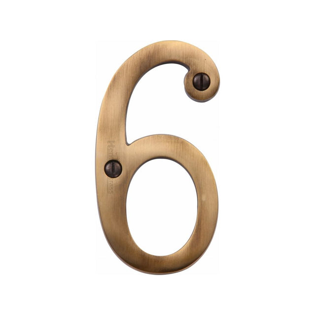 This is an image of a Heritage Brass - Numeral 6 Face Fix 76mm (3") Antique Brass Finish, c1560-6-at that is available to order from Trade Door Handles in Kendal.