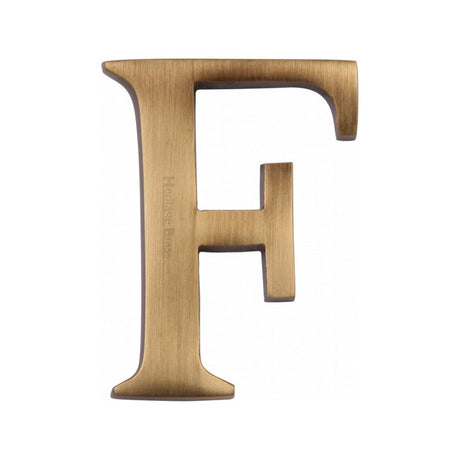 This is an image of a Heritage Brass - Alphabet F Pin Fix 51mm (2") Antique Brass Finish, c1565-2-f-at that is available to order from Trade Door Handles in Kendal.