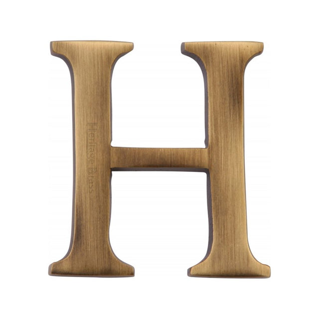 This is an image of a Heritage Brass - Alphabet H Pin Fix 51mm (2") Antique Brass Finish, c1565-2-h-at that is available to order from Trade Door Handles in Kendal.