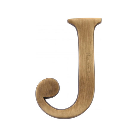 This is an image of a Heritage Brass - Alphabet J Pin Fix 51mm (2") Antique Brass Finish, c1565-2-j-at that is available to order from Trade Door Handles in Kendal.