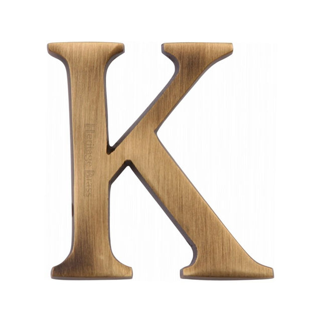 This is an image of a Heritage Brass - Alphabet K Pin Fix 51mm (2") Antique Brass Finish, c1565-2-k-at that is available to order from Trade Door Handles in Kendal.