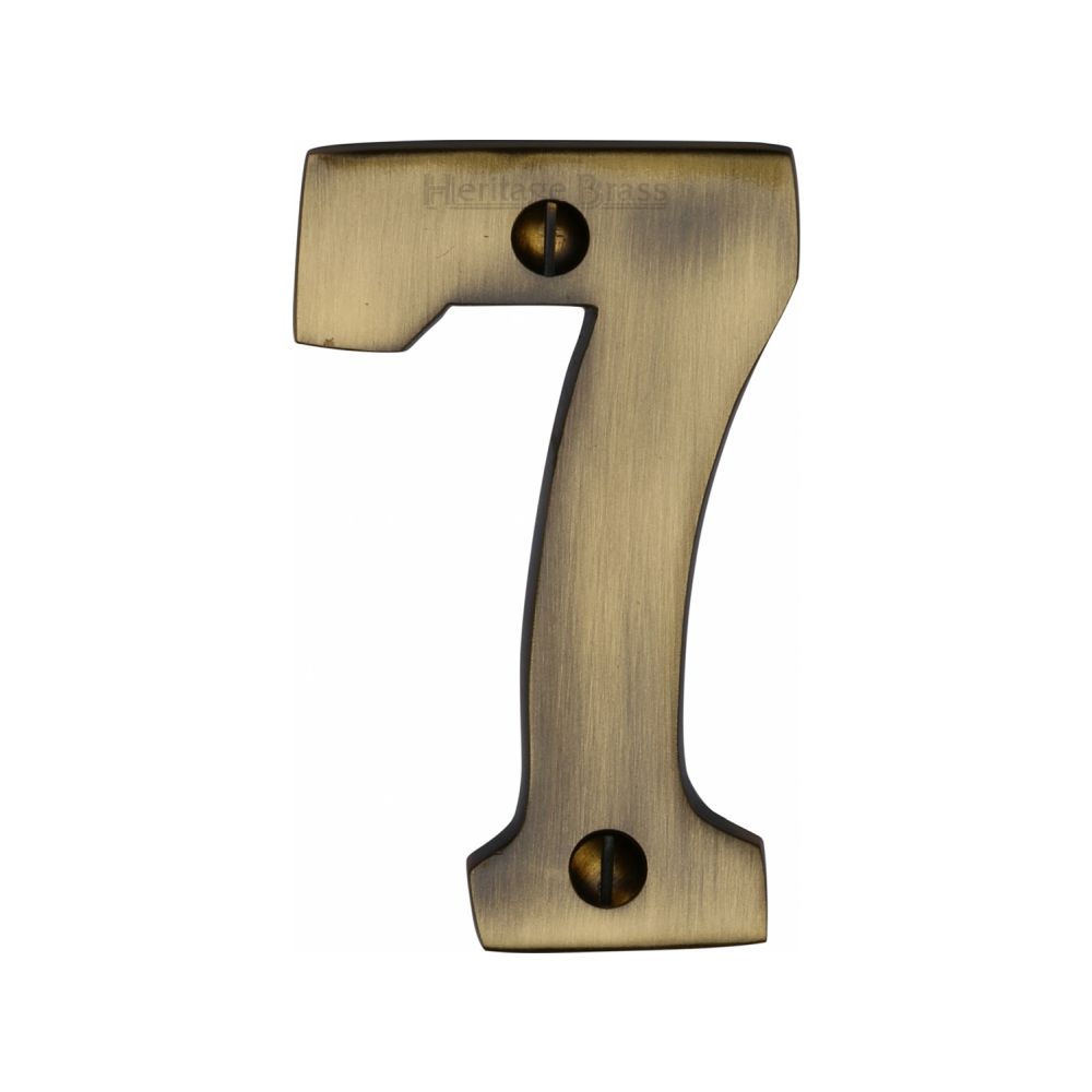 This is an image of a Heritage Brass - Numeral 7 Face Fix 76mm (3") Antique Brass Finish, c1566-7-at that is available to order from Trade Door Handles in Kendal.