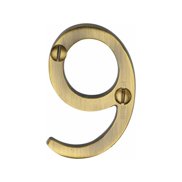 This is an image of a Heritage Brass - Numeral 9 Face Fix 51mm (2") Antique Brass Finish, c1567-9-at that is available to order from Trade Door Handles in Kendal.