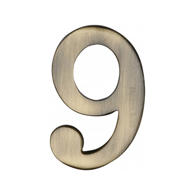 This is an image of a Heritage Brass - Numeral 9 Self Adhesive 51mm (2") Antique Brass Finish, c1568-9-at that is available to order from Trade Door Handles in Kendal.