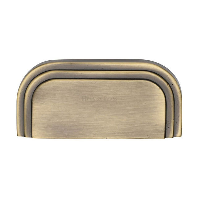 This is a image of a Heritage Brass - Drawer Cup Pull Bauhaus Design 76mm CTC Ant. Brass Finish that is available to order from Trade Door Handles in Kendal