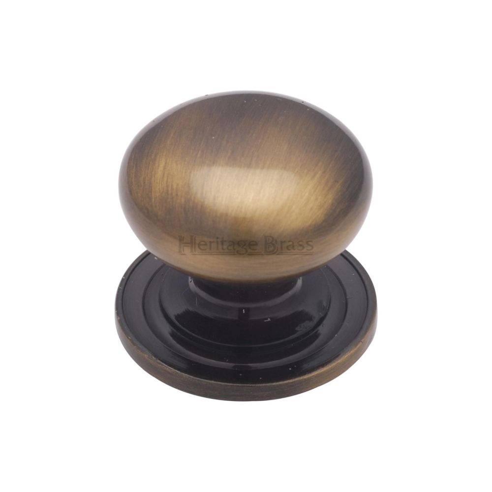 This is a image of a Heritage Brass - Cabinet Knob Victorian Round Design with base 32mm Ant. Brass F that is available to order from Trade Door Handles in Kendal