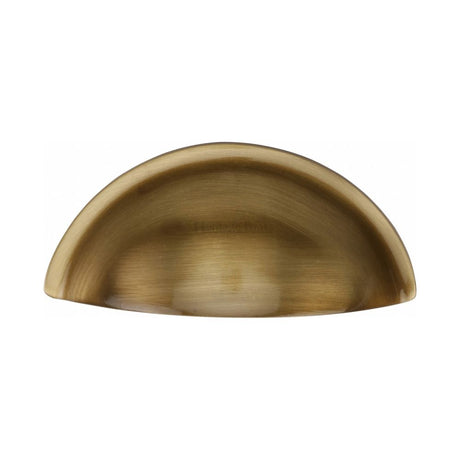 This is an image of a Heritage Brass - Drawer Cup Pull Half Moon Design 57mm CTC Antique Brass Finish, c2760-at that is available to order from Trade Door Handles in Kendal.