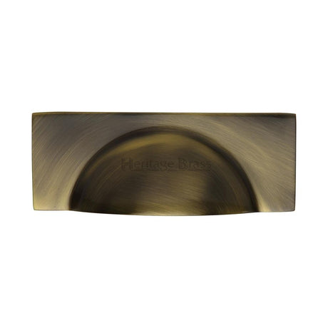 This is an image of a Heritage Brass - Drawer Cup Pull Hampshire Design 57mm CTC Antique Brass Finish, c2764-at that is available to order from Trade Door Handles in Kendal.