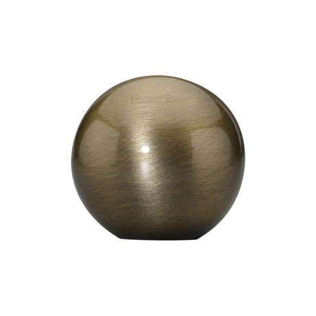 This is an image of a Heritage Brass - Cabinet Knob Globe Design 25mm Antique Brass Finish, c3627-at that is available to order from Trade Door Handles in Kendal.