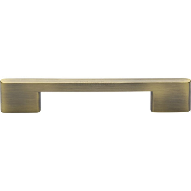 This is an image of a Heritage Brass - Cabinet Pull Slim Metro Design 128mm CTC Antique Brass Finish, c3681-128-at that is available to order from Trade Door Handles in Kendal.