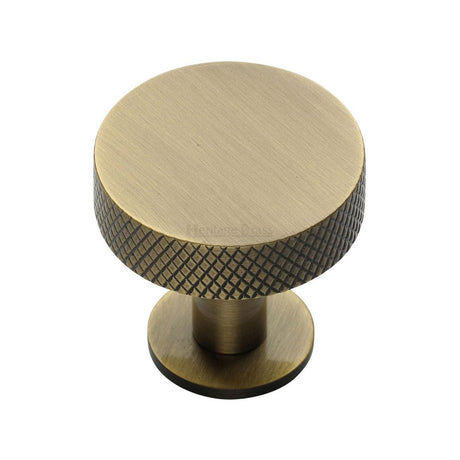 This is an image of a Heritage Brass - Cabinet Knob Disc Knurled Design with Rose 32mm Antique Brass Fini, c3882-32-at that is available to order from Trade Door Handles in Kendal.