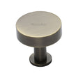 This is a image of a Heritage Brass - Cabinet Knob Disc Design with Rose 32mm Ant. Brass Finish that is available to order from Trade Door Handles in Kendal