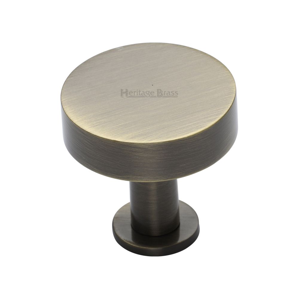 This is a image of a Heritage Brass - Cabinet Knob Disc Design with Rose 32mm Ant. Brass Finish that is available to order from Trade Door Handles in Kendal