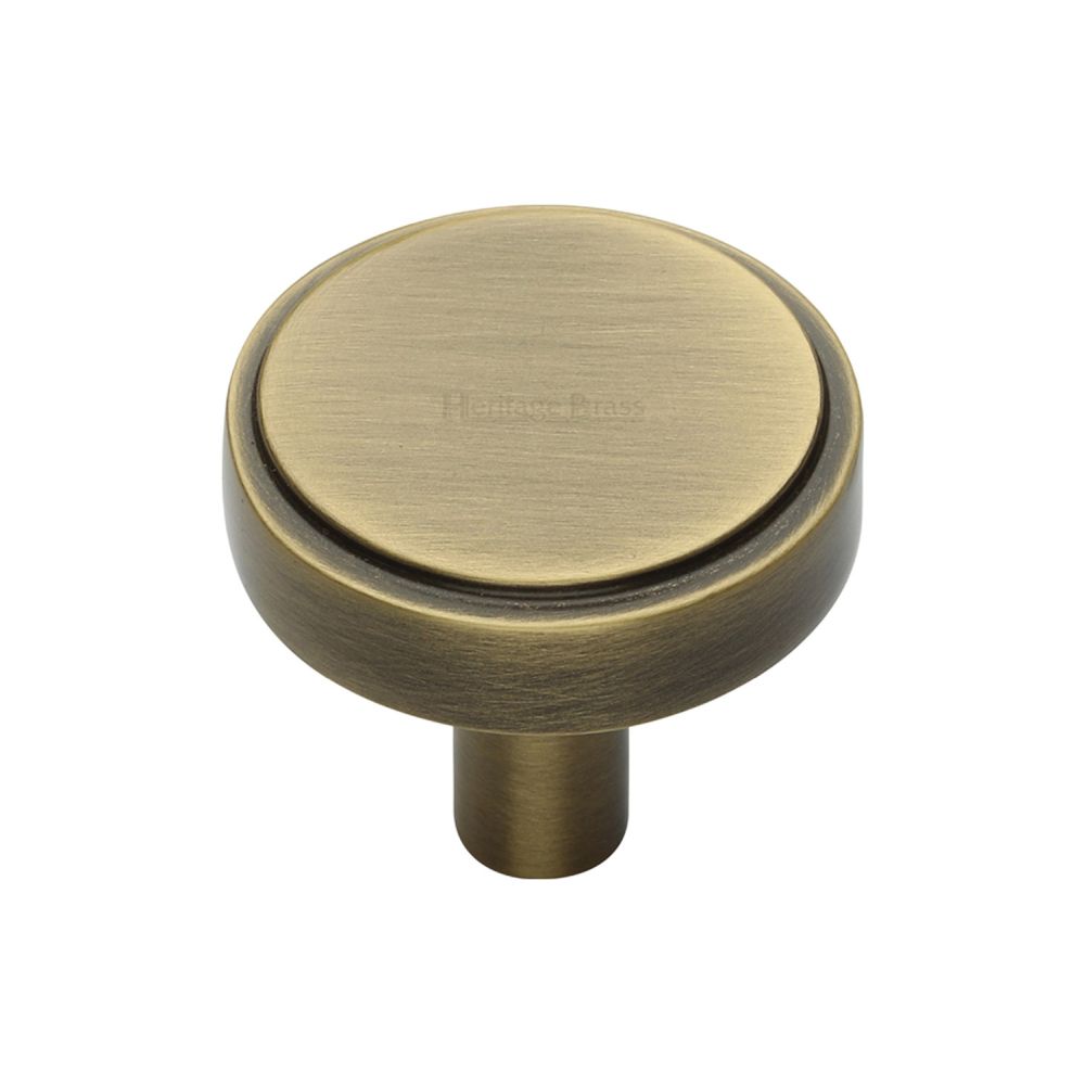 This is an image of a Heritage Brass - Cabinet Knob Stepped Disc Design 32mm Antique Brass Finish, c3952-32-at that is available to order from Trade Door Handles in Kendal.